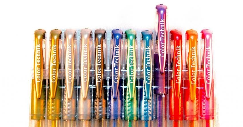 Metallic gel pens for adult coloring — Color Technik set fanned out on dark paper